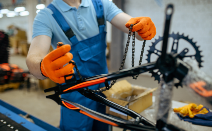 Man holding the chain of a bicycle